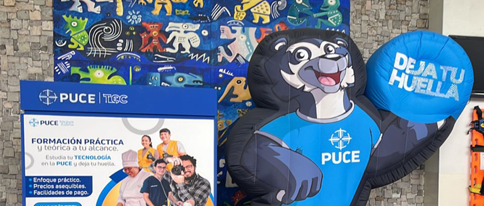 PUCE promotional display featuring the institution’s Andean bear mascot and practical education campaign